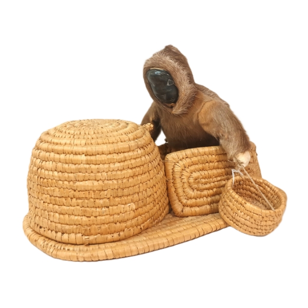 MAN ENTERING IGLOO BY JOHNNY INUKPUK (1911 - 2007) - GRASS, FUR & STONE