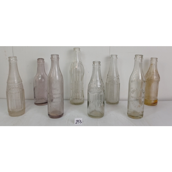 LOT OF 8 - CLEAR & PURPLE TINTED EMBOSSED SODA BOTTLES - INCL HOSMER, W.M. ROBERTSON, ETC