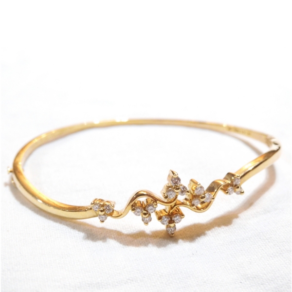 Lady's 18K Yellow Gold Diamond Hinged Cuff Bracelet. Total weight of 11.09 grams.