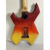 Image 4 : Modified B.C. Rich Warlock electric guitar with a custom painted red, yellow, and black finish 