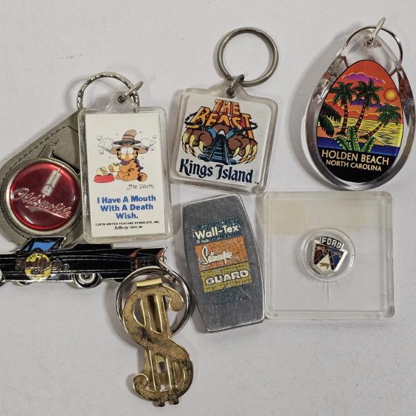 Collection Of Vintage Souvenir Keychains, Novelty Lapel Pins, And Advertising Pocket Tools