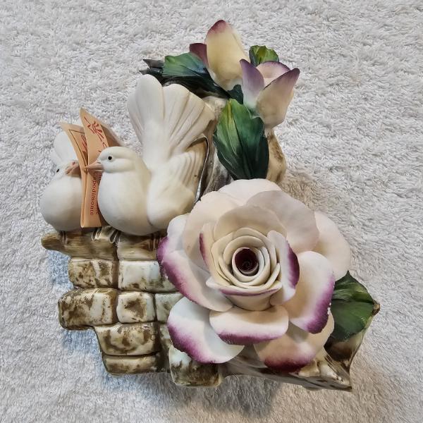 Capodimonte Napoleon Porcelain Figurine with Two Small White Doves Perched on a Textured Stone Wall