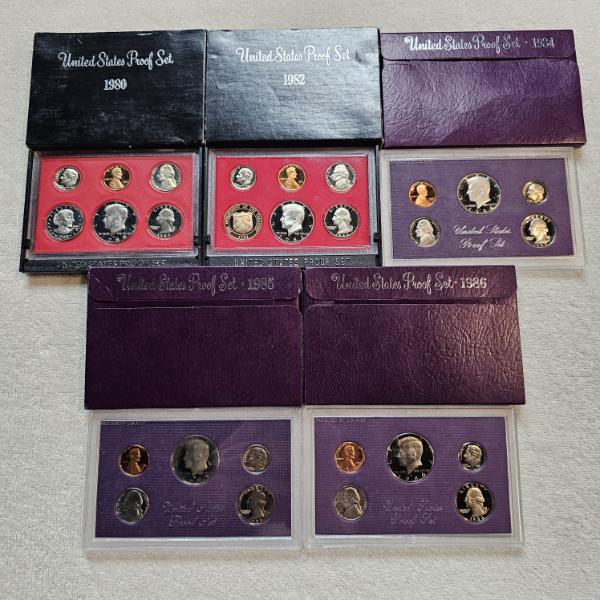 Five Official United States Mint Proof Sets spanning the years 1980, 1982, 1984, 1985, and 1986