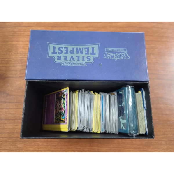 Large Lot of Assorted Pokemon Trading Cards Including Rares, Holos, & Reverse Holos in Box W/ Sleeve