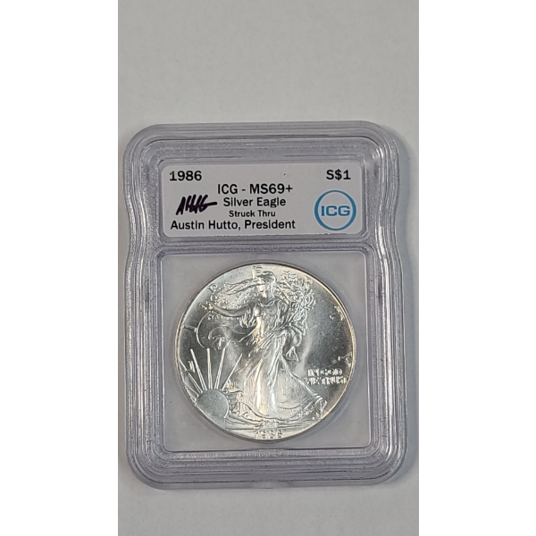 ICG 1986 MS69+ "Struck Thru"1 Troy Ounce .999 Fine Silver American Eagle Signed By Austin Hutto