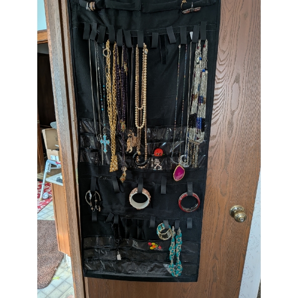 Over Door Organizer Of Costume Pieces Shown