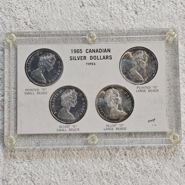 1965 Canadian .800 Silver Dollar "Type Set" housed in a plastic holder