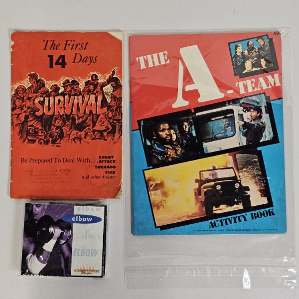 The A-Team Activity Book, The First 14 Days Survival Booklet, and a Nikken KenkoTherm Elbow Wrap