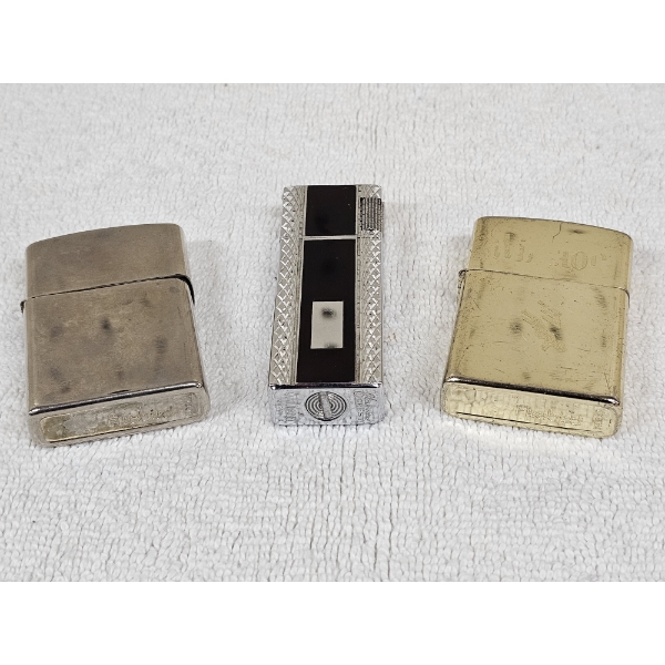 Three Lighters Including a Vintage Flame Crest Valiant Butane Lighter Made In Japan from the 1970's
