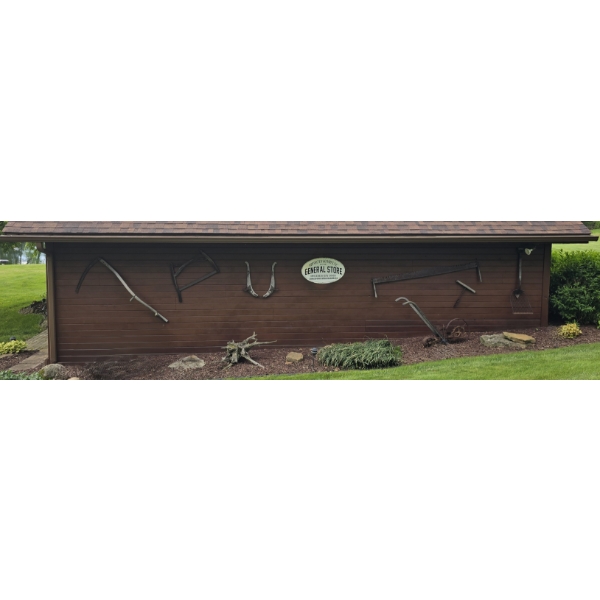 Vintage Tools, General Store Sign on Side of Barn & Plow in Flower Bed Only