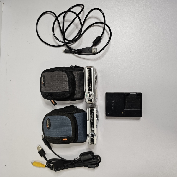 Two Sony Cyber-shot Cameras, With Cases, Charger, And Cables