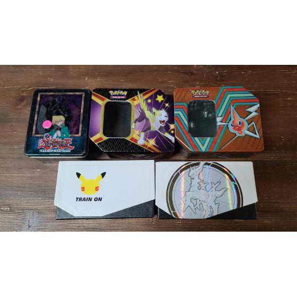 Assorted Pokémon & Yu-Gi-Oh Tins/Cases Dice/Card Sleeves & Other Accessories