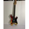 Image 1 : Modified B.C. Rich Warlock electric guitar with a custom painted red, yellow, and black finish 