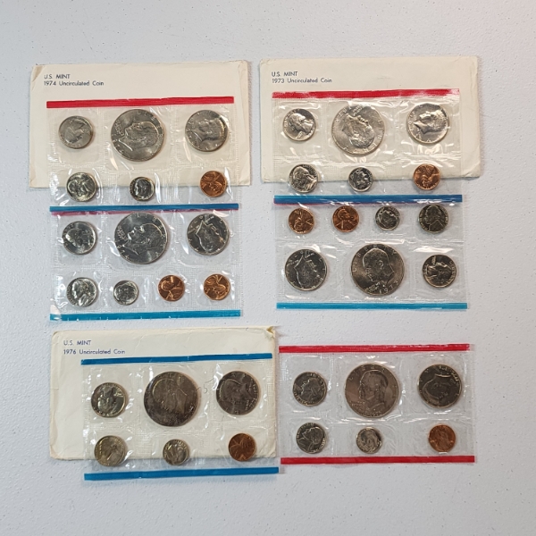 Three United States Mint Uncirculated Coin Sets: 1974, 1973, 1976