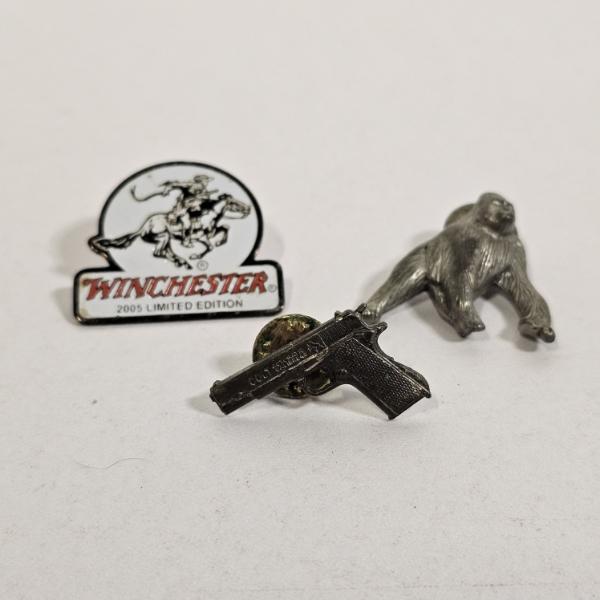 Three Vintage Pewter and Metal Collectible Pins featuring Brands like Winchester and Colt