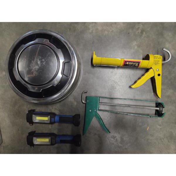 Metal Hub Cap, Two Caulk Guns, And Two Flash Lights