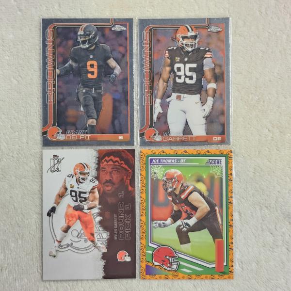 Four Cleveland Browns Football Trading Cards Including Grant Delpit, Myles Garrett, and Joe Thomas