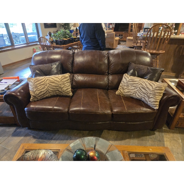 Luxurious Rich Brown Leather Couch With Beautiful Throw Pillows Included