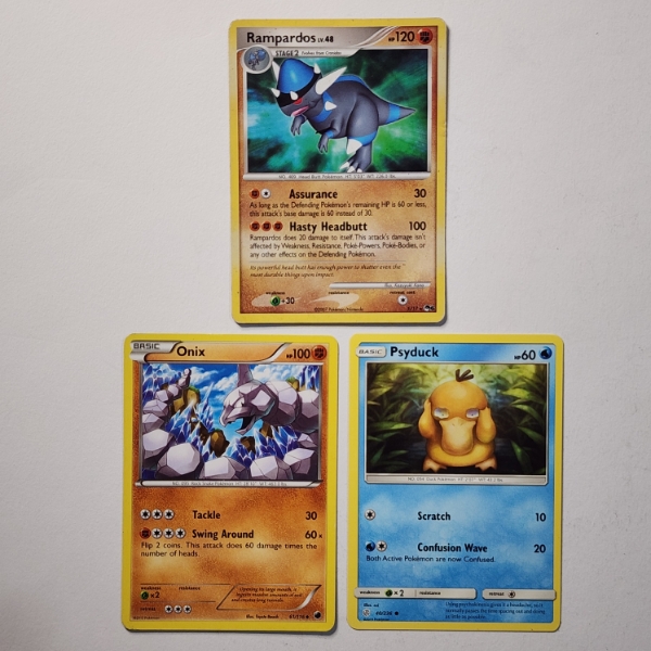 Three Vintage Pokemon Trading Cards Including Rampardos, Onix & Psyduck