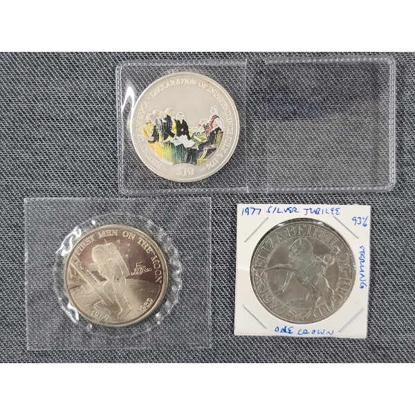 Three Assorted Coins Including 1989 First Men on the Moon $5 Coin, Silver Jubilee & America History
