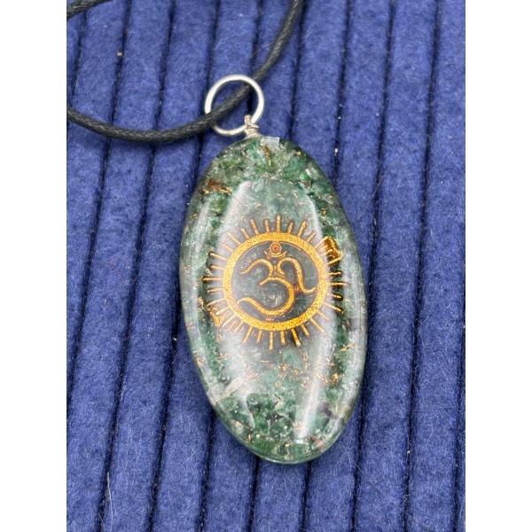 Oval Green Crystal Pendant with Striking Gold Om Symbol centered within radiant sunburst design 