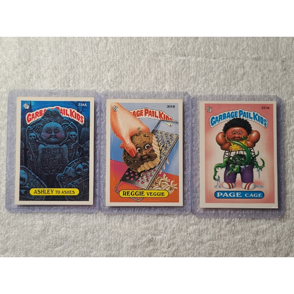 Three 1987 Topps Garbage Pail Kids Cards - 334A Ashley to Ashes, 305B Reggie Veggie & 331A Page Cage