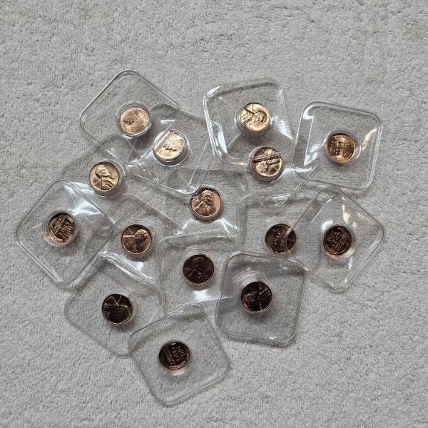 Assortment of BU Proof-Like United States Pennies in Protective Plastic Casings FV: $.40