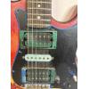 Image 6 : Modified B.C. Rich Warlock electric guitar with a custom painted red, yellow, and black finish 