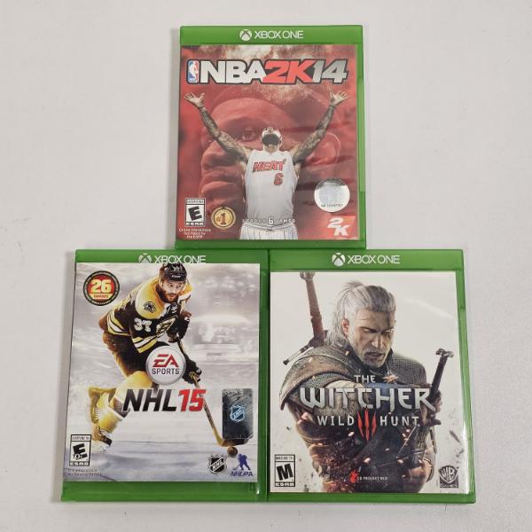 Collection of Xbox One games including NBA 2K14, NHL 15, and The Witcher 3: Wild Hunt
