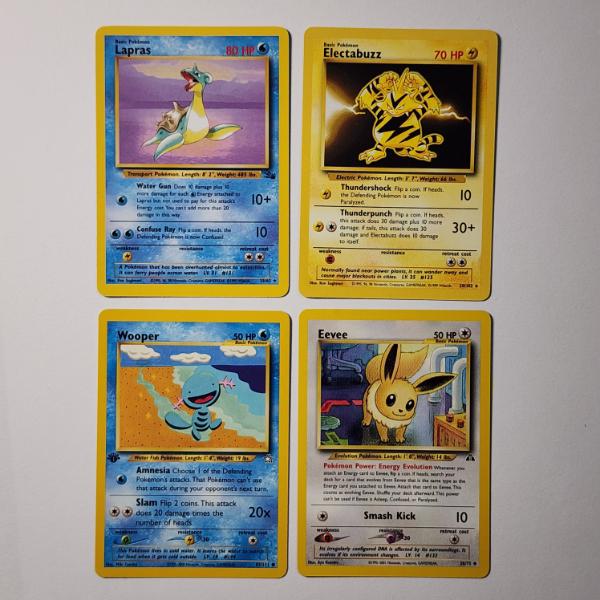 Four Assorted Vintage Pokemon Trading Cards Including Two Rares, Eevee & 1ST EDITION WOOPER