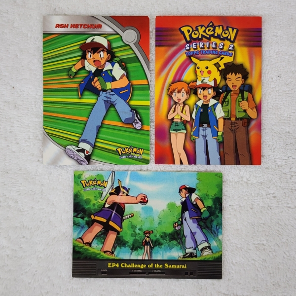 Three Assorted Vintage Topps Pokemon Trading Cards Including ASH KETCHUM!