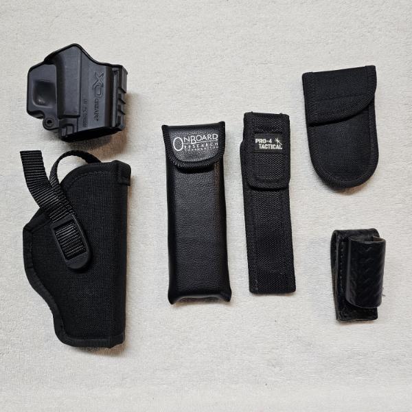 Assortment of Various Gun Holsters and Magazine Pouches