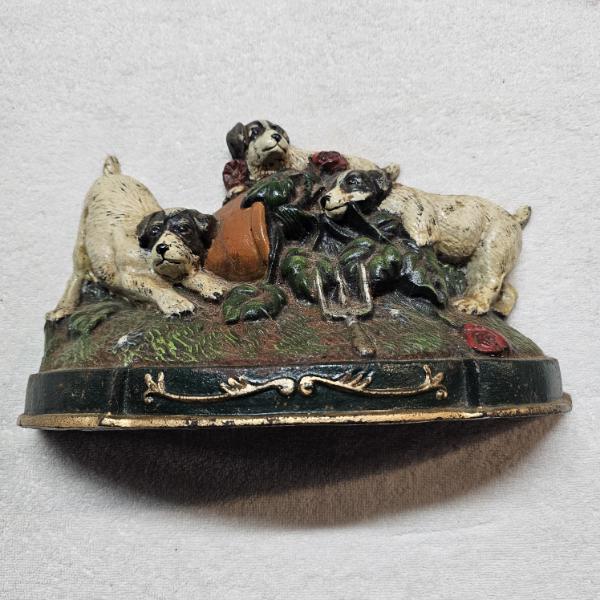 Antique Cast Iron Doorstop depicting Three Puppies playing around an Overturned Flower Pot
