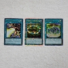 Image 1 : Three Assorted Holo Magic Yu-Gi-Oh Trading Cards!