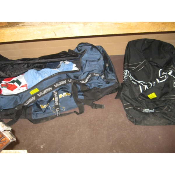 2 LG. HOCKEY BAGS W/MISC. SHIRTS, ETC.