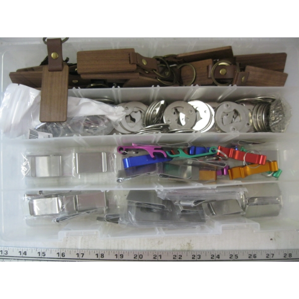 PLASTIC CONTAINER OF MONEY CLIPS, BOTTLE OPENERS, KEYCHAIN ITEMS