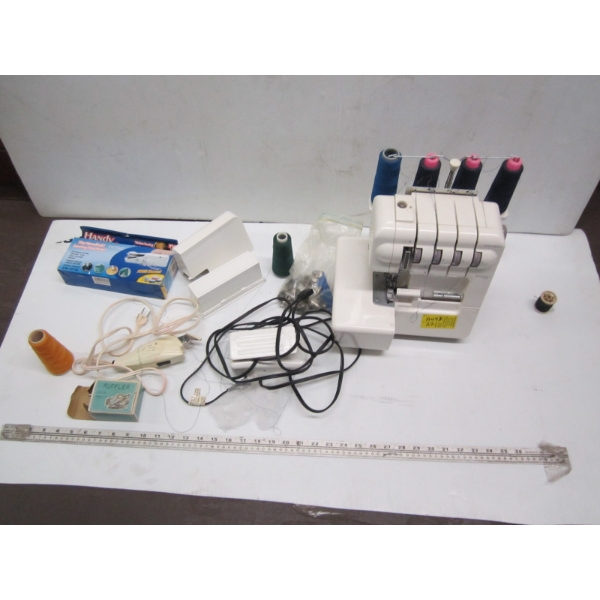 SERGER SEWING MACHINE & BAG OF ACCESS.