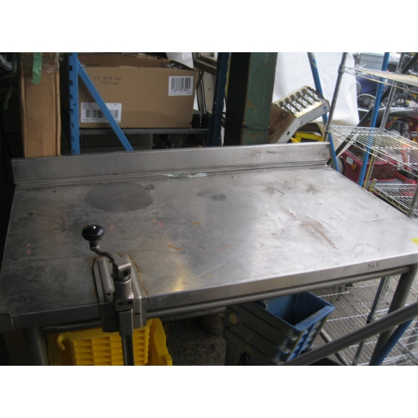 APPROX. 4'X28" STAINLESS STEEL TABLE W/CAN OPENER ATTACHED