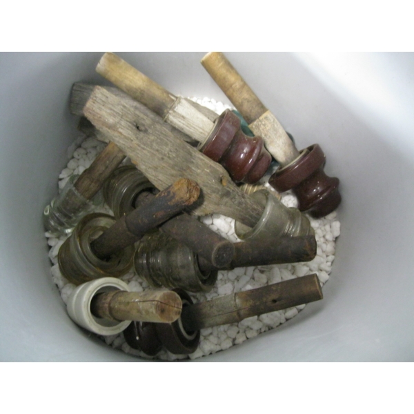 BIN OF ASST. INSULATORS ON POSTS