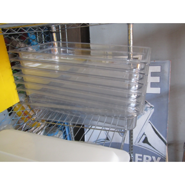STACK OF CLEAR FOOD PANS