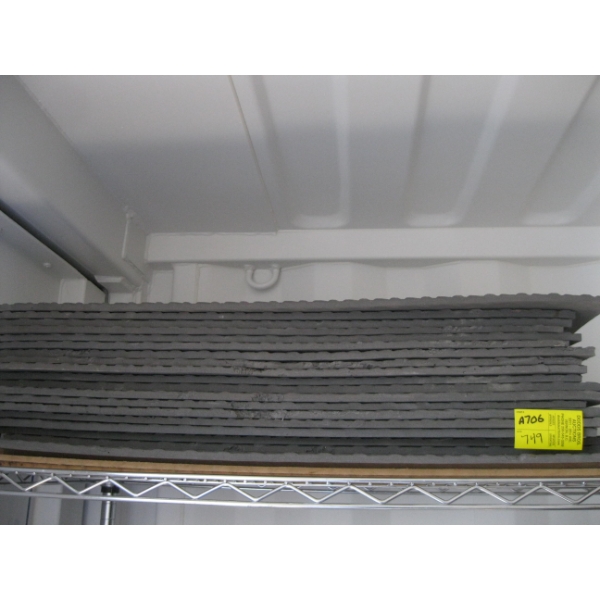 STACK OF GREY FLOOR MATS