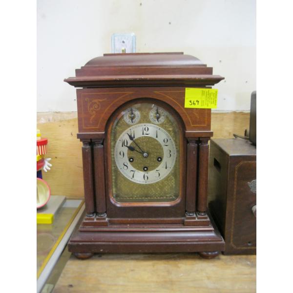 WOOD CASED WIND UP CLOCK - HAS PENDULUM & KEY, SEEMS TO BE RUNNING, NOT SURE ABOUT CHIME