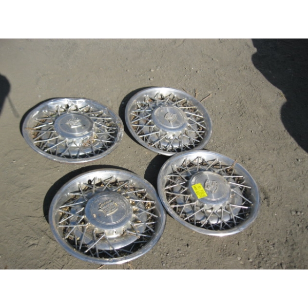 SET OF 4 CADILLAC HUBCAPS - SOME DAMAGE