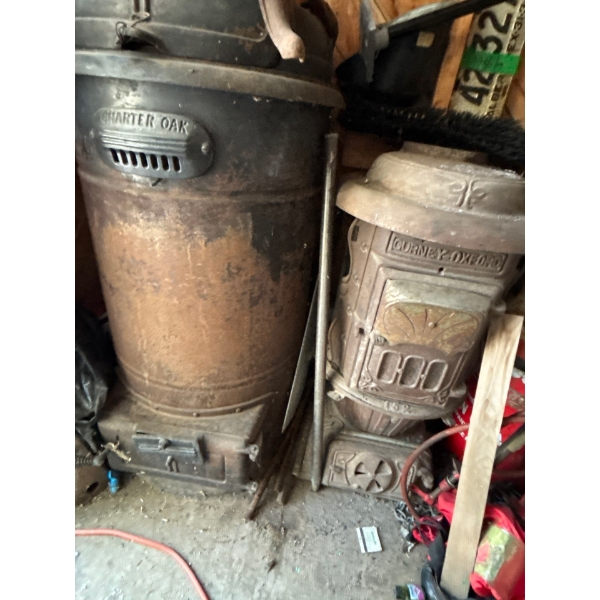 two antique woodburning heaters charter Oak and CURNEY Oxford # 152 with bases buyer must  pick up o