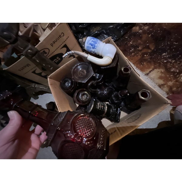 Collection of red Avon wine, glasses, decanter, and other Avon collectables