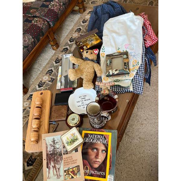 large box of linens  short glass set Stein barometer knife, set Alberta, wildlife magazines, and ano