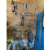 Image 1 : pegboard with various tools, including bolt cutters gear, polars, hacksaw, bungee cords, vice grips,