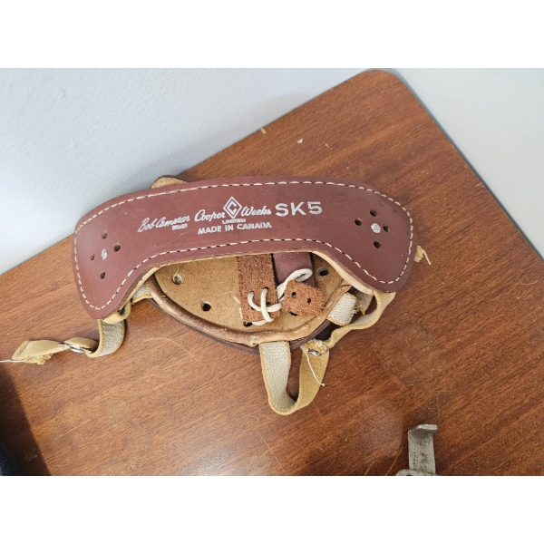 Vintage Ice Hockey Equipment Including Gloves, Pads, and Blades