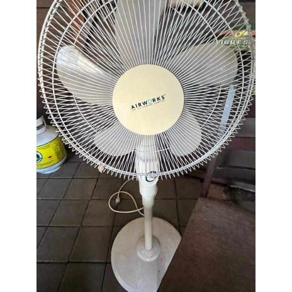Air Work stand-up fan with wooden chair.