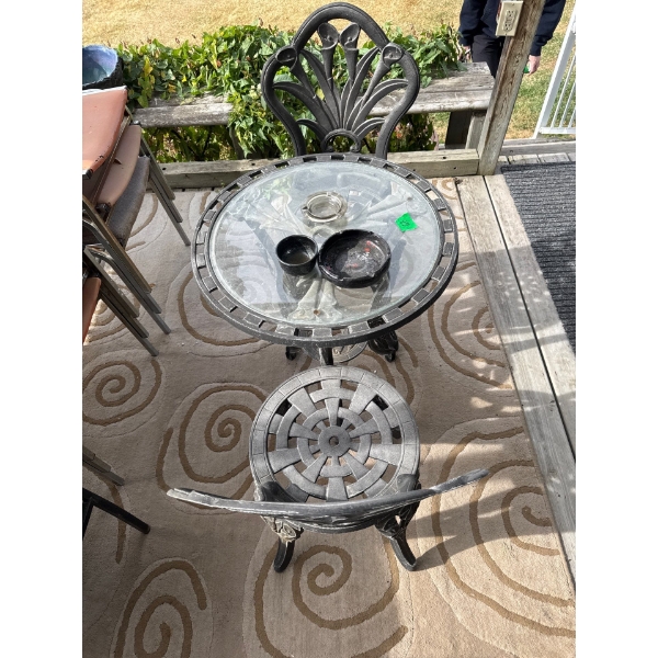 cast iron table and two chairs, 23 1/2 inches wide table top, 28” tall, 6 vintage leather metal chai
